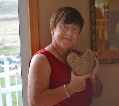 Anne Arnal holds a stone heart found on the farm land. The family has found heart shaped rocks of all sizes since Blake died in 2008. 